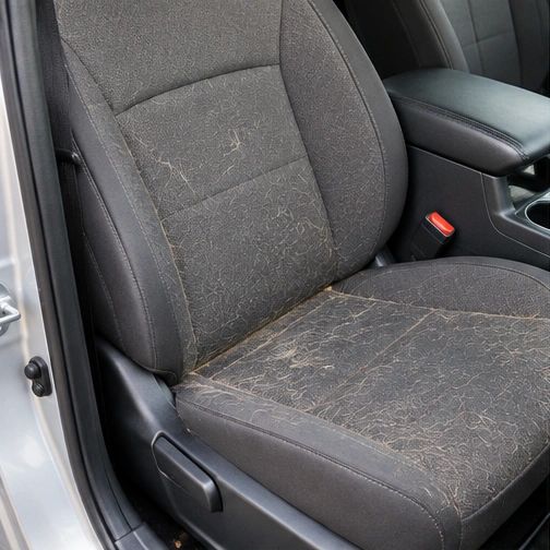 Illustrative car seat with dirt and pet hair